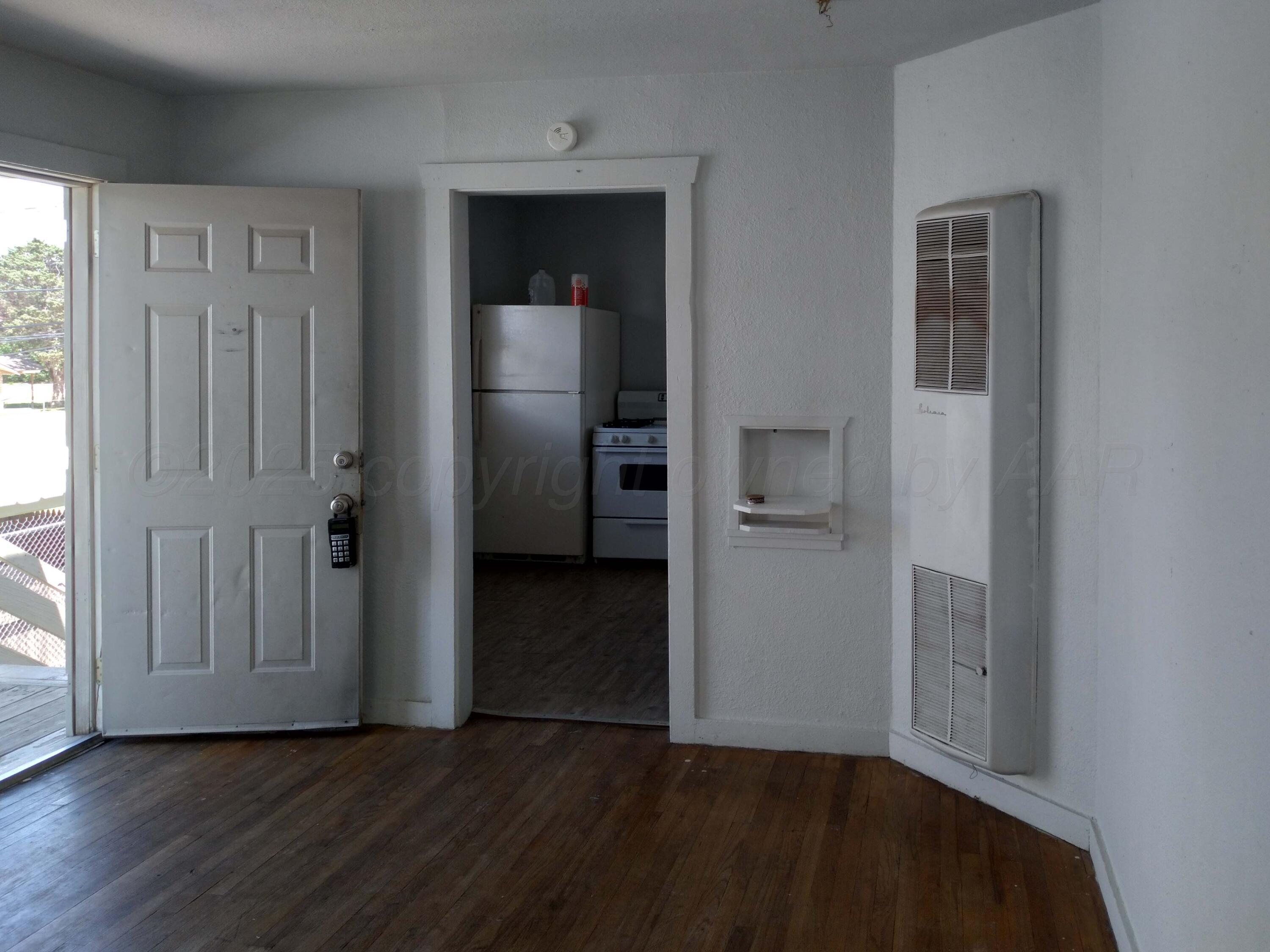 809 South Bryan Street Amarillo, TX 79106 - Photo 15 of 22 an empty room with wooden floor closet and windows
