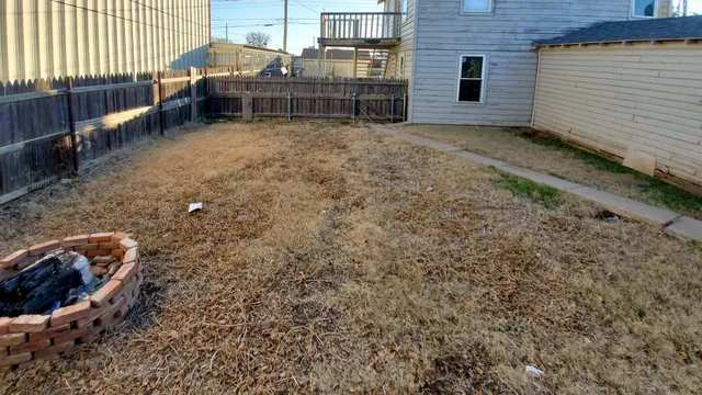 a backyard of a house with outdoor seating