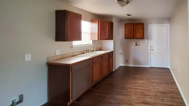 a kitchen with a sink and a mirror