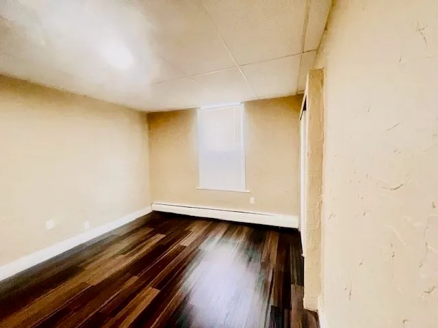 a view of room with wooden floor and window