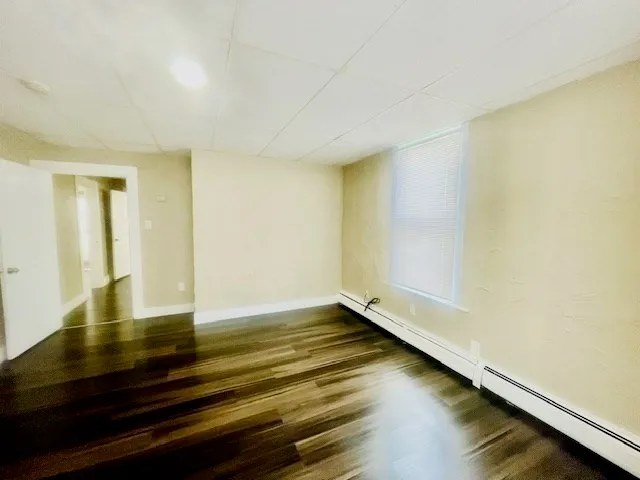 a view of room with wooden floor