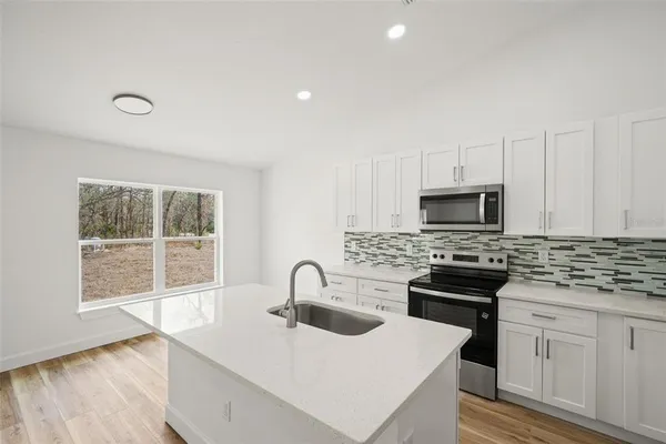 a kitchen with sink and window