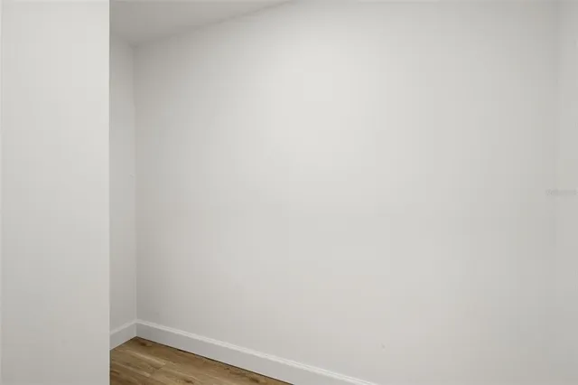 a view of a room with wooden floor and white doors