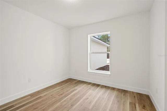 a spacious bathroom with a double vanity sink a mirror and shower