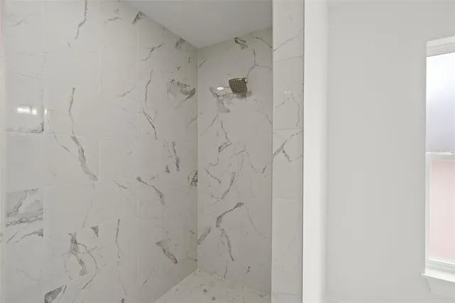 a front view of a house with a garden and yard