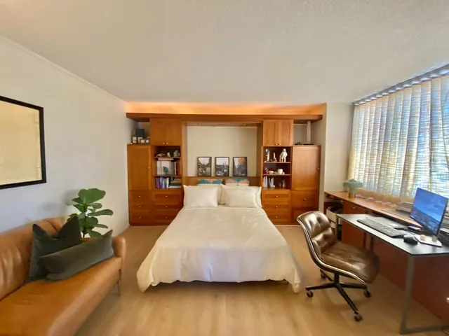 a spacious bedroom with a bed and furniture