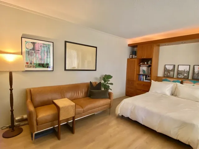 a bedroom with a bed and couch