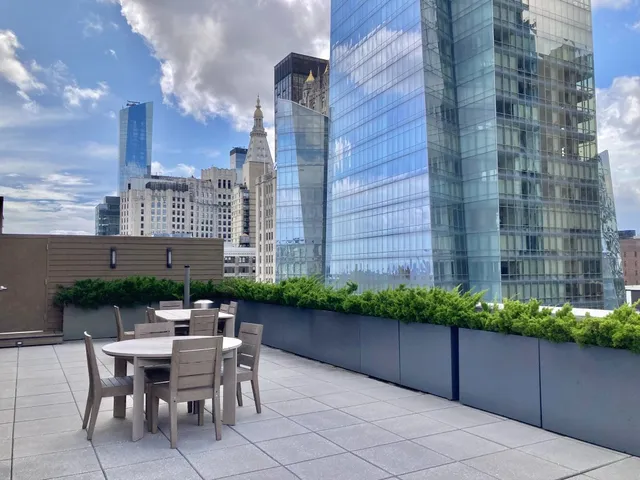 a backyard of a house with a yard and outdoor seating