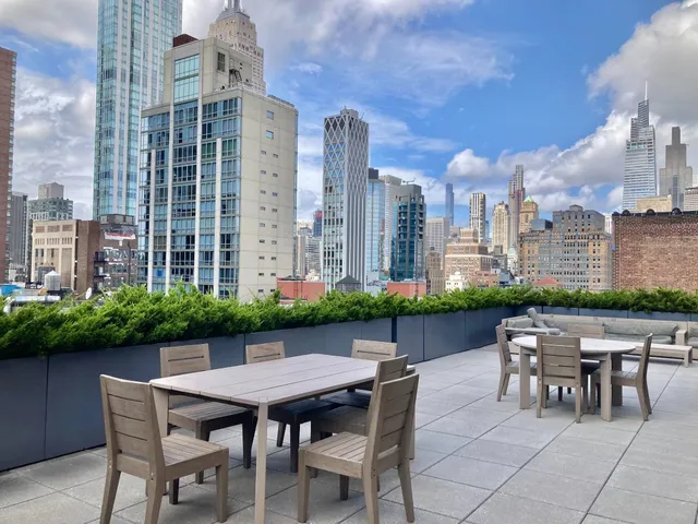 a view of a patio with table and chairs and potted plants