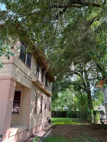 a view of a house with a tree