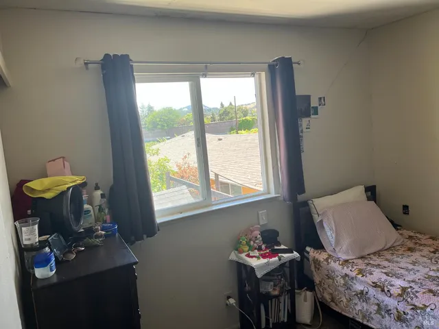 a bedroom with a bed and a window