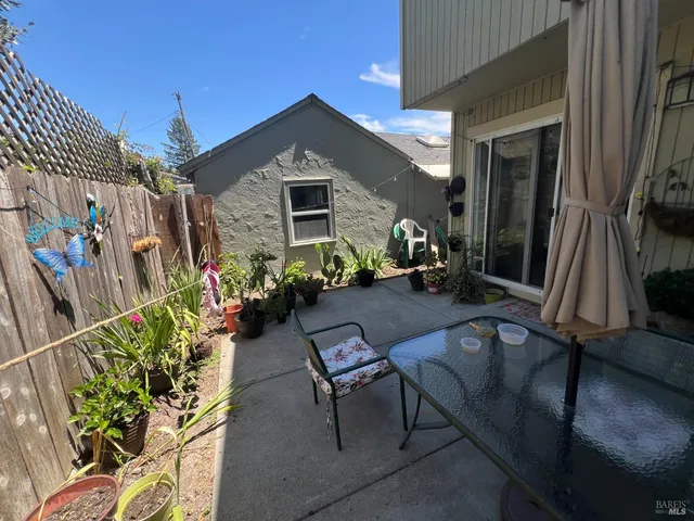 a front view of a house with outdoor seating