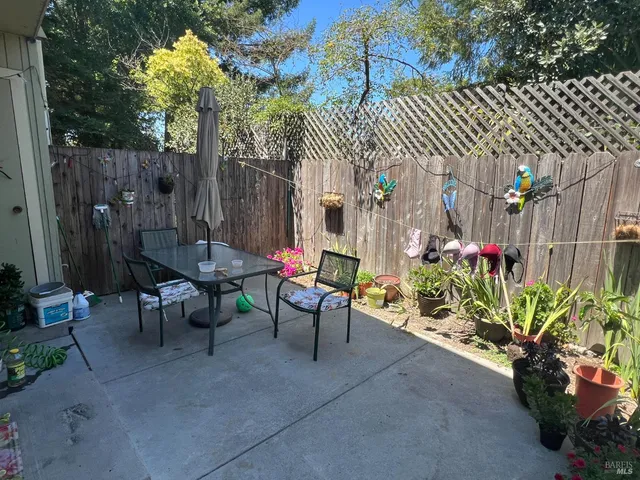 a view of a chairs and table in backyard