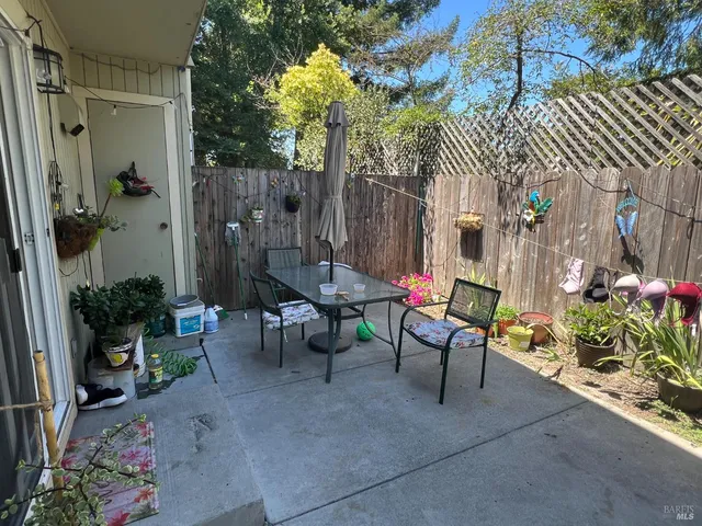 a view of a chairs and table in a backyard