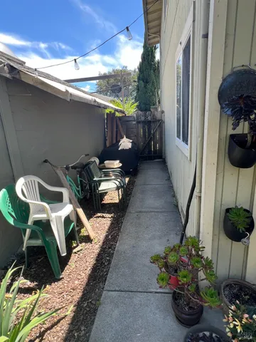 a view of a patio with table and chairs potted plants with wooden floor