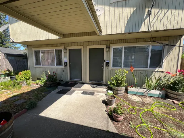 a view of a house with backyard and sitting area