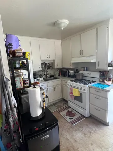 a kitchen with a sink appliances and cabinets