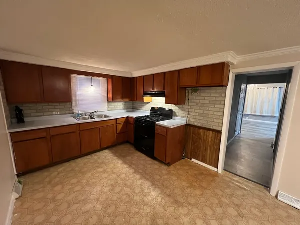 a kitchen with stainless steel appliances granite countertop a stove a sink dishwasher and a refrigerator