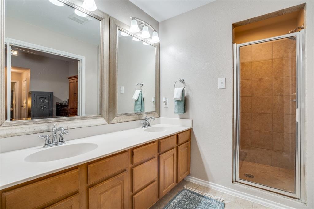 108 High Meadows Court Decatur, TX 76234 - Photo 13 of 29 a bathroom with a double vanity sink mirror and shower