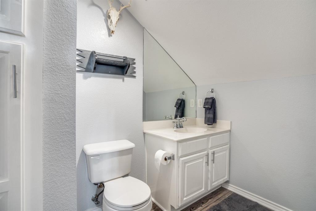 108 High Meadows Court Decatur, TX 76234 - Photo 19 of 29 a bathroom with a toilet sink and mirror
