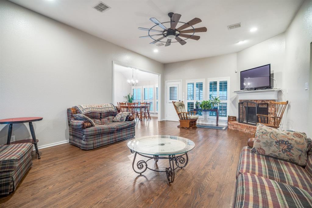 108 High Meadows Court Decatur, TX 76234 - Photo 4 of 29 a living room with furniture a fireplace and a flat screen tv