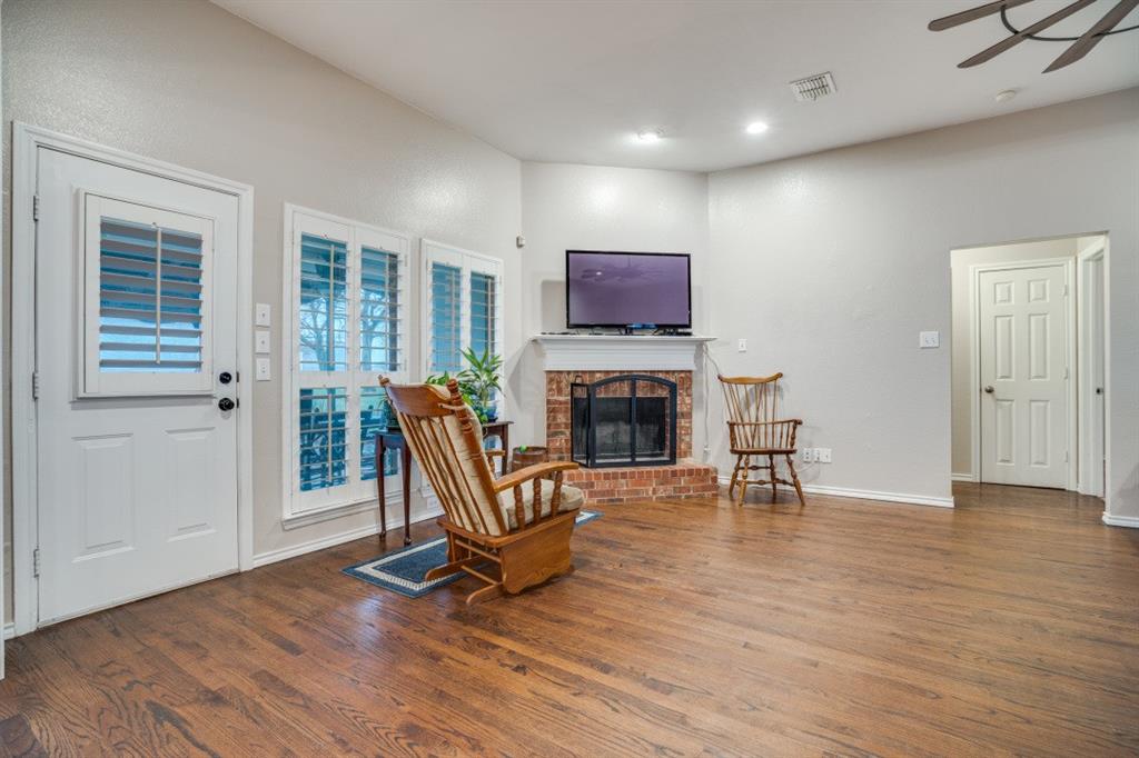 108 High Meadows Court Decatur, TX 76234 - Photo 5 of 29 a living room with furniture a fireplace and a flat screen tv