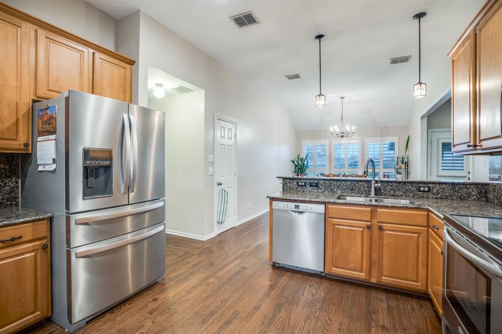 108 High Meadows Court Decatur, TX 76234 - Photo 8 of 29 a kitchen with stainless steel appliances granite countertop a refrigerator a sink and a stove