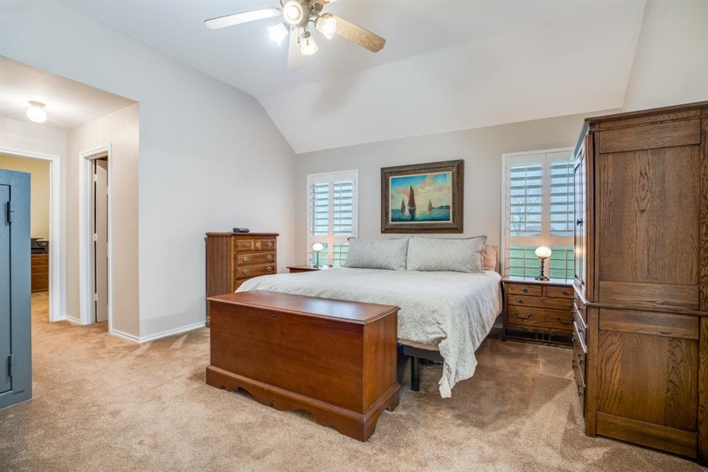 108 High Meadows Court Decatur, TX 76234 - Photo 10 of 29 a bedroom with a bed and a refrigerator