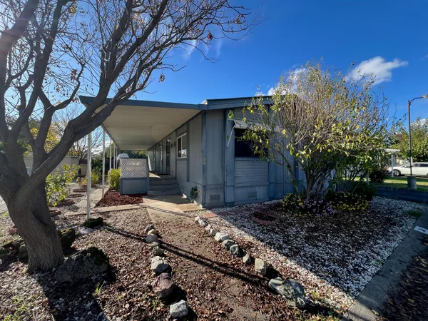 a view of a house with a yard fire pit and outdoor seating