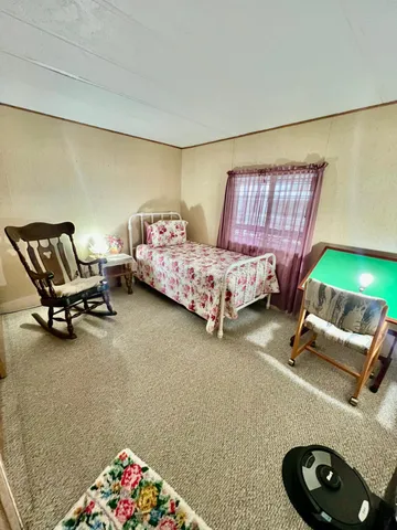 a bedroom with bed and a window