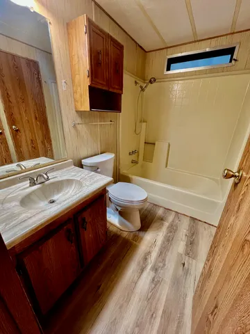 a bathroom with a sink mirror vanity and toilet