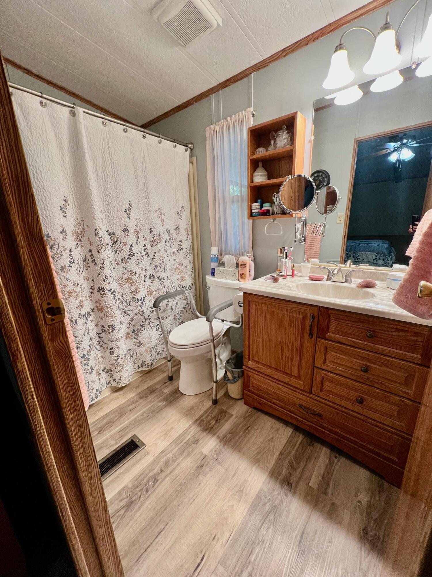 180 South Main Street, Unit SPC 36 Red Bluff, CA 96080 - Photo 16 of 18 a bathroom with a sink mirror vanity and toilet