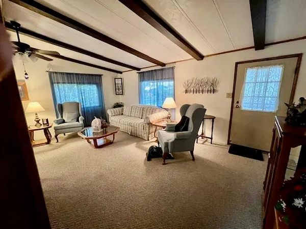 a view of a livingroom with furniture and a window