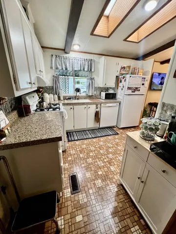a kitchen with a stove and a refrigerator