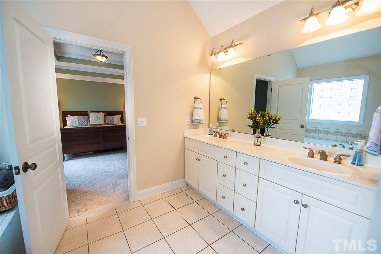 81 Rand Road Raleigh, NC 27603 - Photo 12 of 24 a en suite bathroom with double sink and mirror