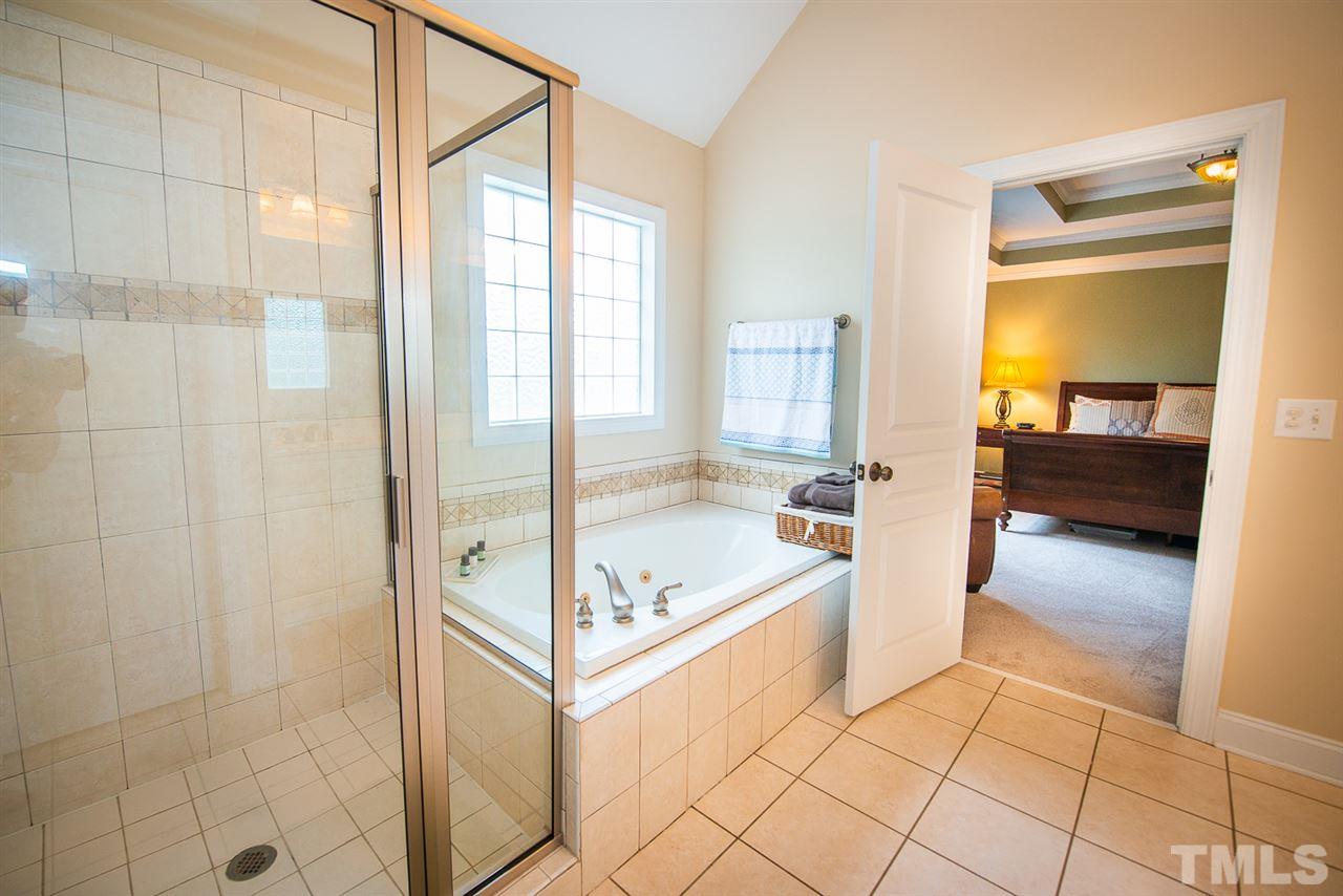 81 Rand Road Raleigh, NC 27603 - Photo 13 of 24 a spacious bathroom with a tub and mirror