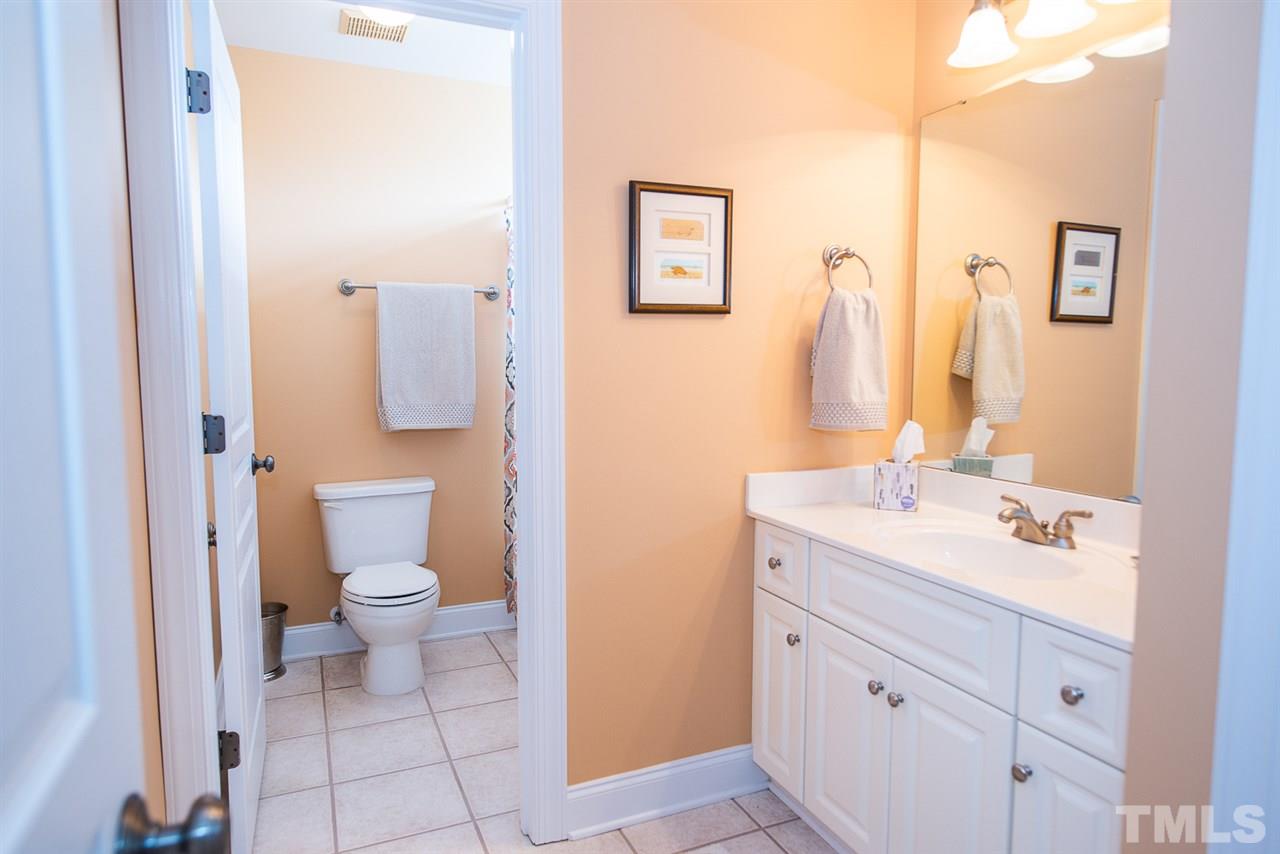 81 Rand Road Raleigh, NC 27603 - Photo 15 of 24 a bathroom with a sink a toilet and a mirror
