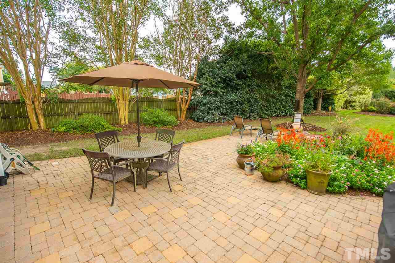 81 Rand Road Raleigh, NC 27603 - Photo 20 of 24 a view of patio with table and chairs under an umbrella