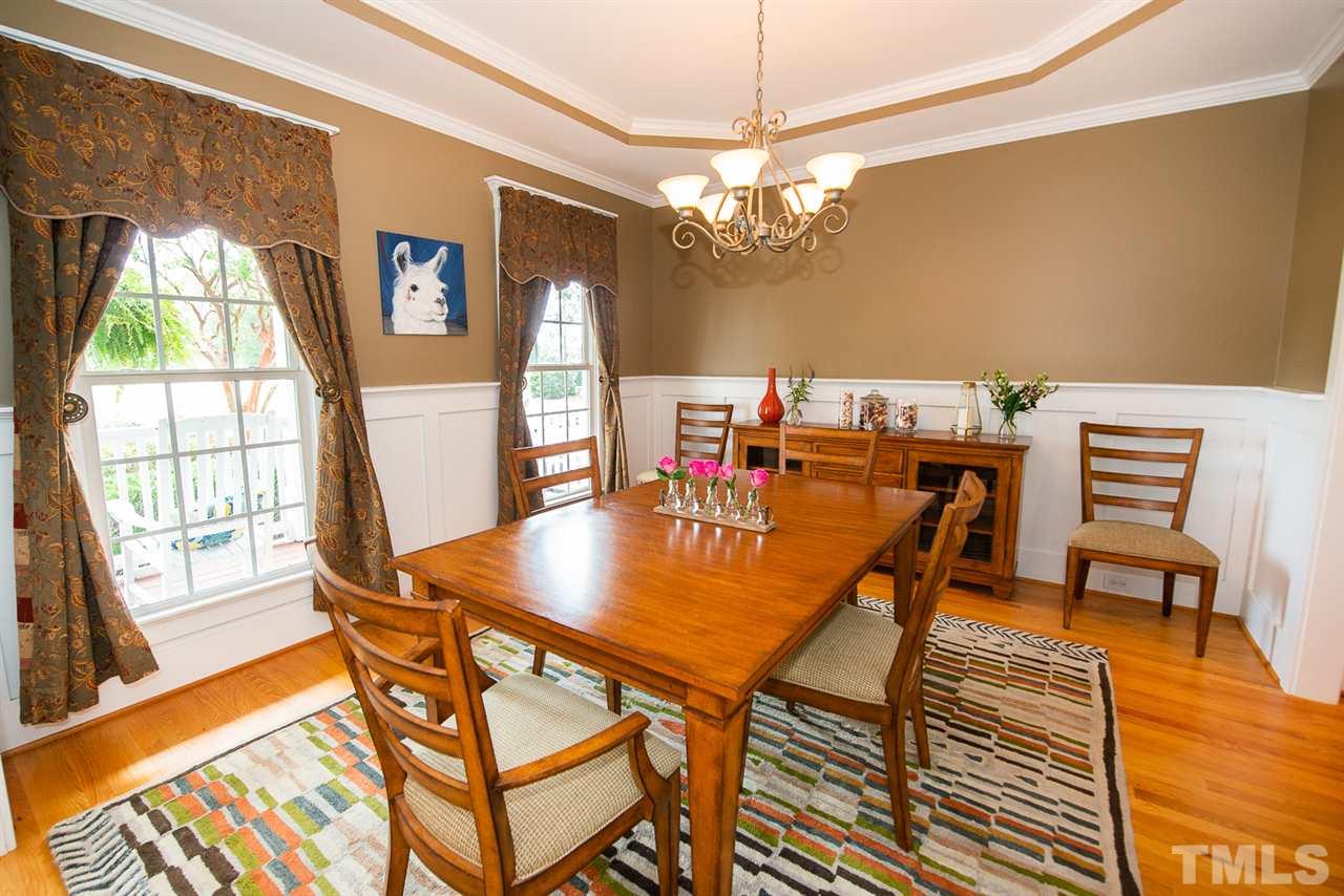 81 Rand Road Raleigh, NC 27603 - Photo 3 of 24 a view of a dining room with furniture a chandelier and wooden floor
