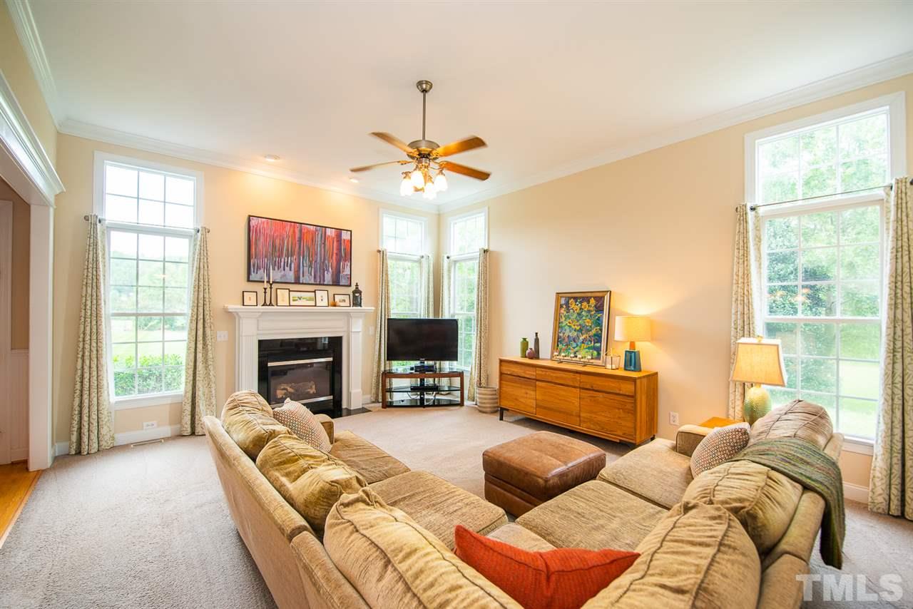 81 Rand Road Raleigh, NC 27603 - Photo 5 of 24 a living room with furniture fireplace and a flat screen tv
