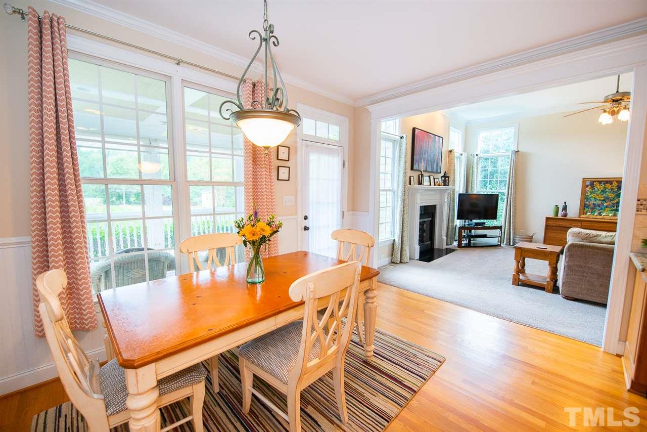 81 Rand Road Raleigh, NC 27603 - Photo 7 of 24 a living room with furniture a chandelier and a table