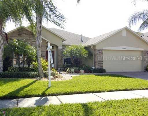 16206 Rambling Road Odessa, FL 33556 - Photo 1 of 1 a view of a house with a yard and palm trees