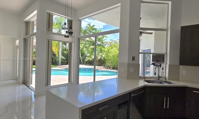 a view of kitchen with furniture and large window