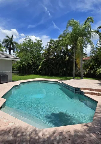 a view of a swimming pool with a yard
