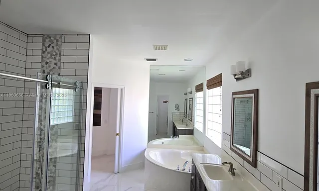 a spacious bathroom with a shower and a sink