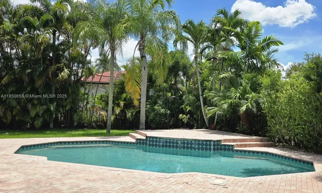 a view of a swimming pool with a garden