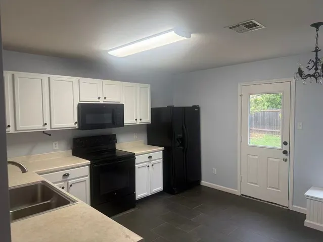 a kitchen with a refrigerator stove and sink