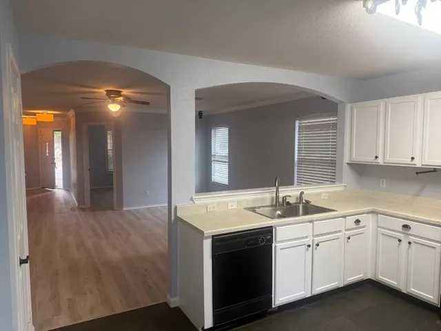 a kitchen with cabinets appliances and a sink