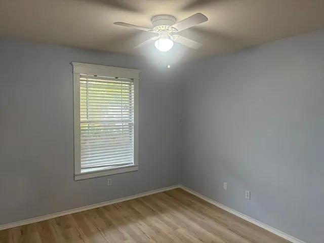 a view of a room with a window and a fan