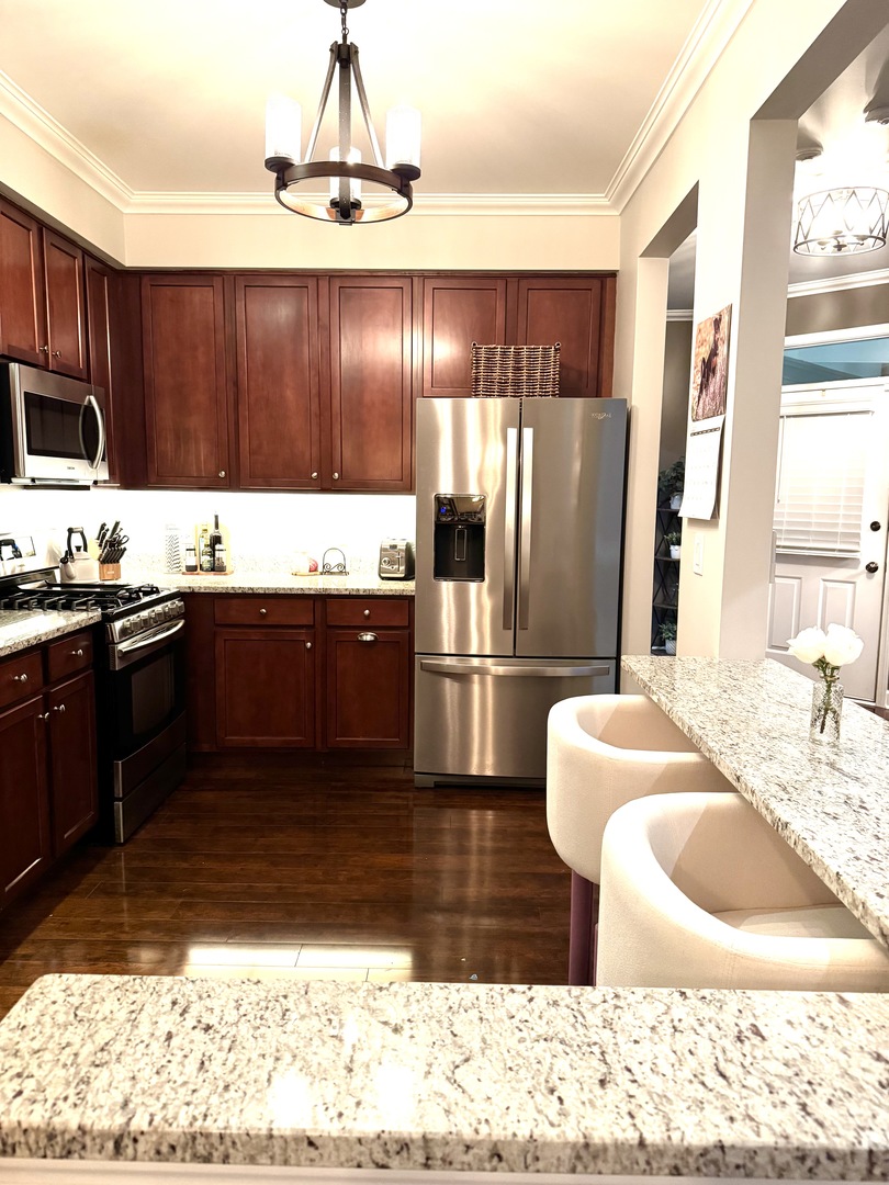 2827 White Thorn Circle Naperville, IL 60564 - Photo 6 of 26 a kitchen with stainless steel appliances granite countertop a sink refrigerator and cabinets